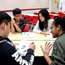 Students discussing school workin the classroom.