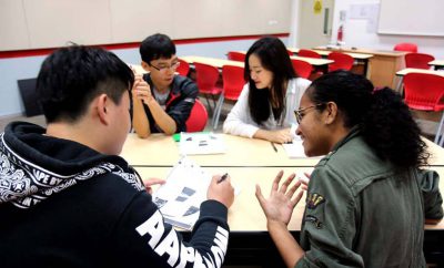 Students discussing school workin the classroom.