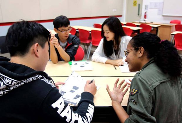 Students discussing school workin the classroom.