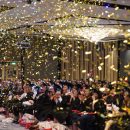 confetti poppers fill the room as the emcee congratulates the graduates on their achievements.