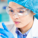 Lady analysing a lab experiment in the science lab.