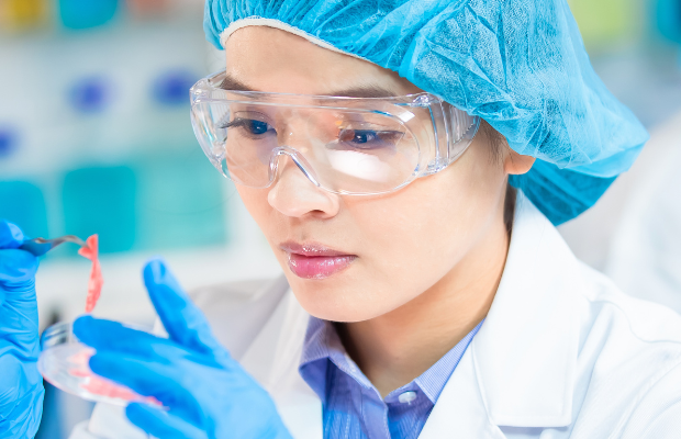 Lady analysing a lab experiment in the science lab.