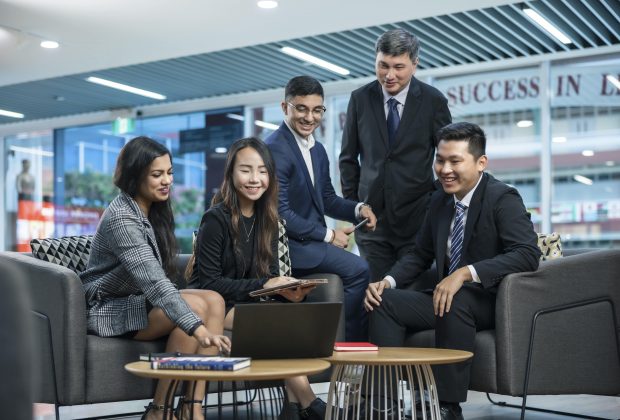 business professionals looking at a computer screen.