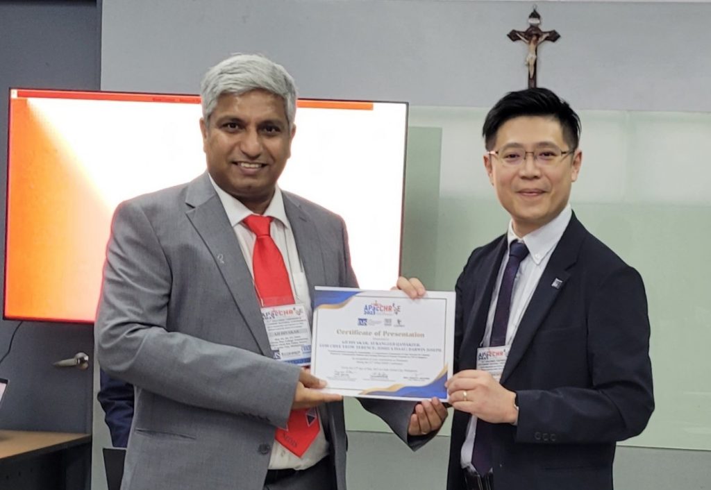 MDIS Tourism and Hospitality lecturer receiving a certificate of presentation at the ApacChrie conference.
