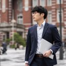 male asian business student in formal wear carrying a laptop