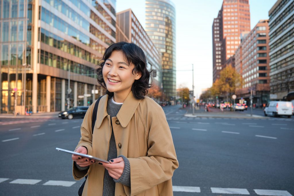 A young female Asian student exploring the bustling city overseas.