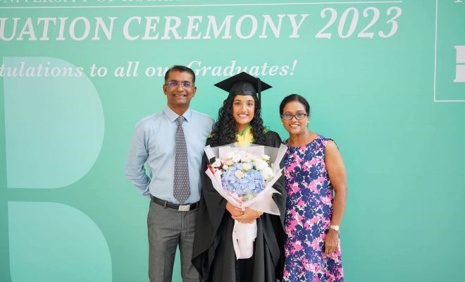 An MDIS graduate posing with her parents for a photo at the MDIS- University of Roehampton London Graduation Ceremony 2023.