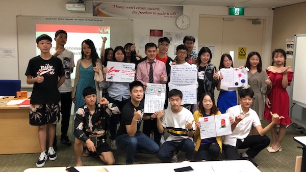 A group of students posing for a picture during class.