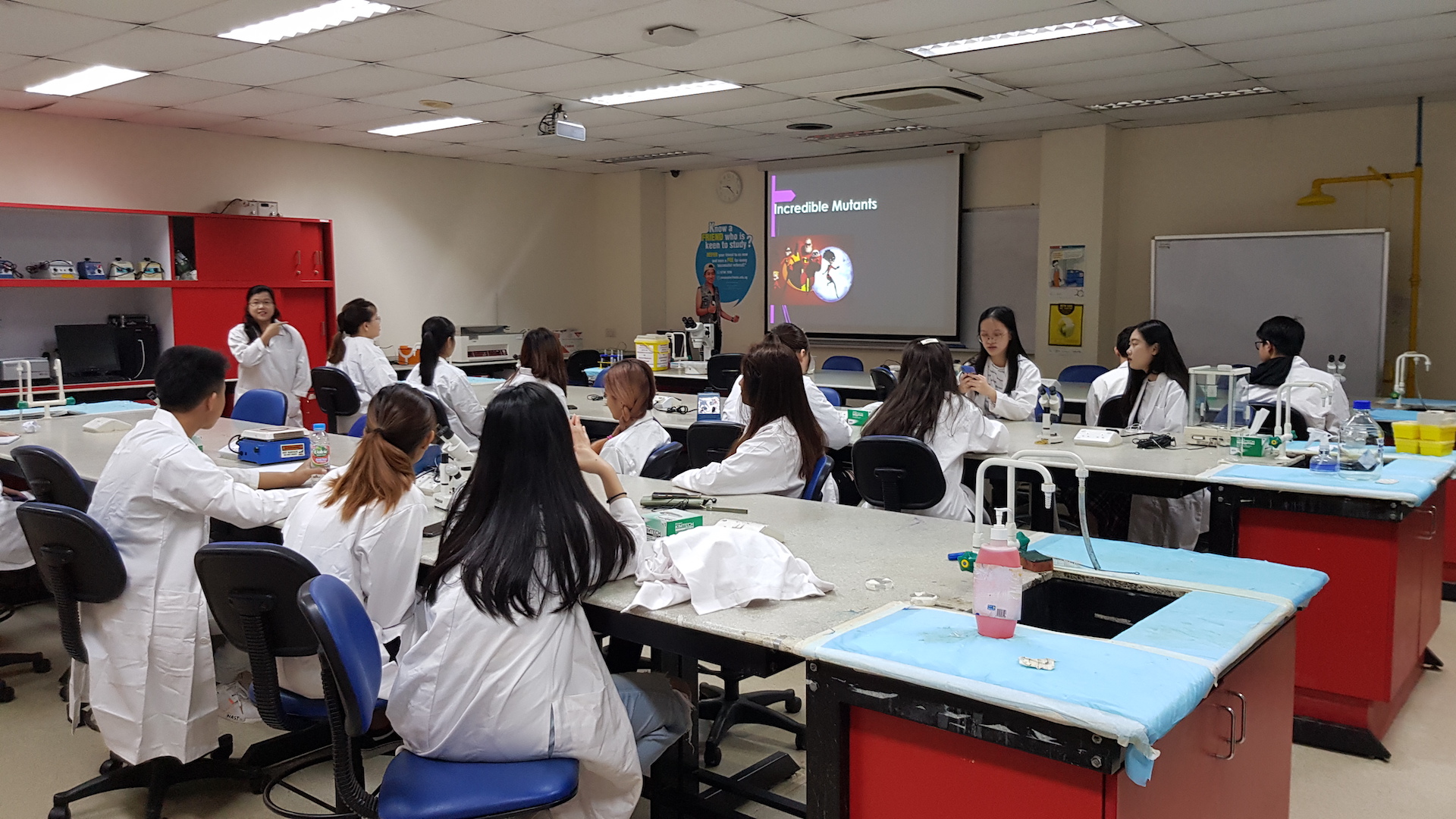 MDIS college students in the science lab.