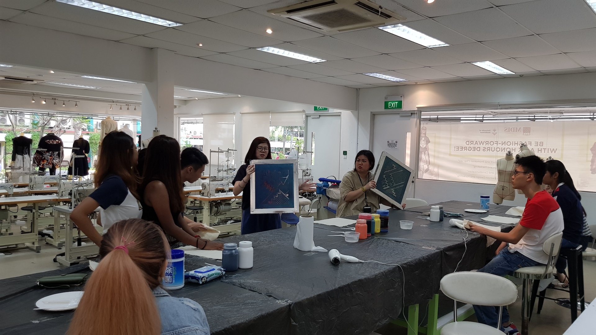 MDIS college students get a brief on what they need to do at the fashion lab.