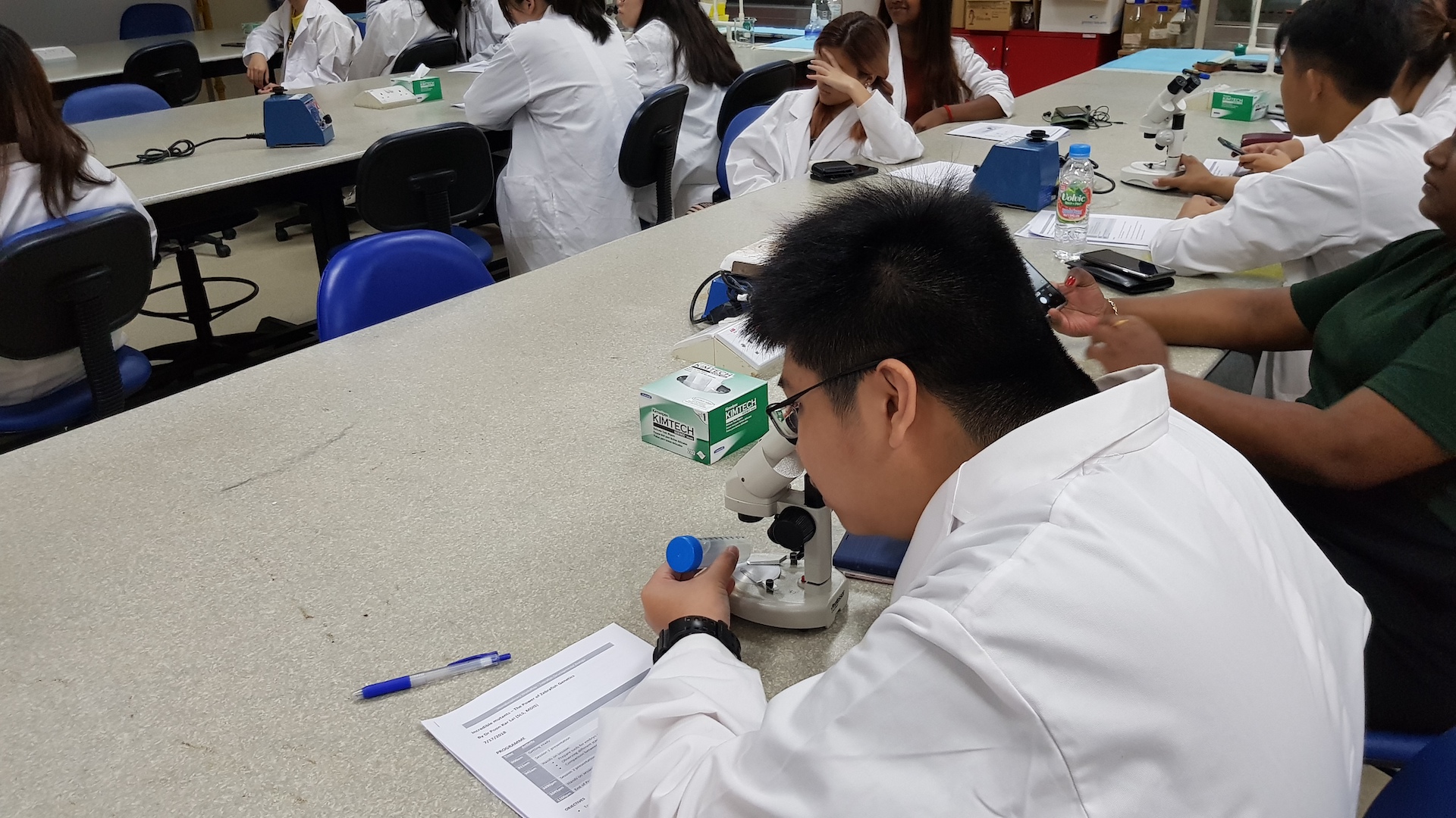 MDIS college students in the science lab.