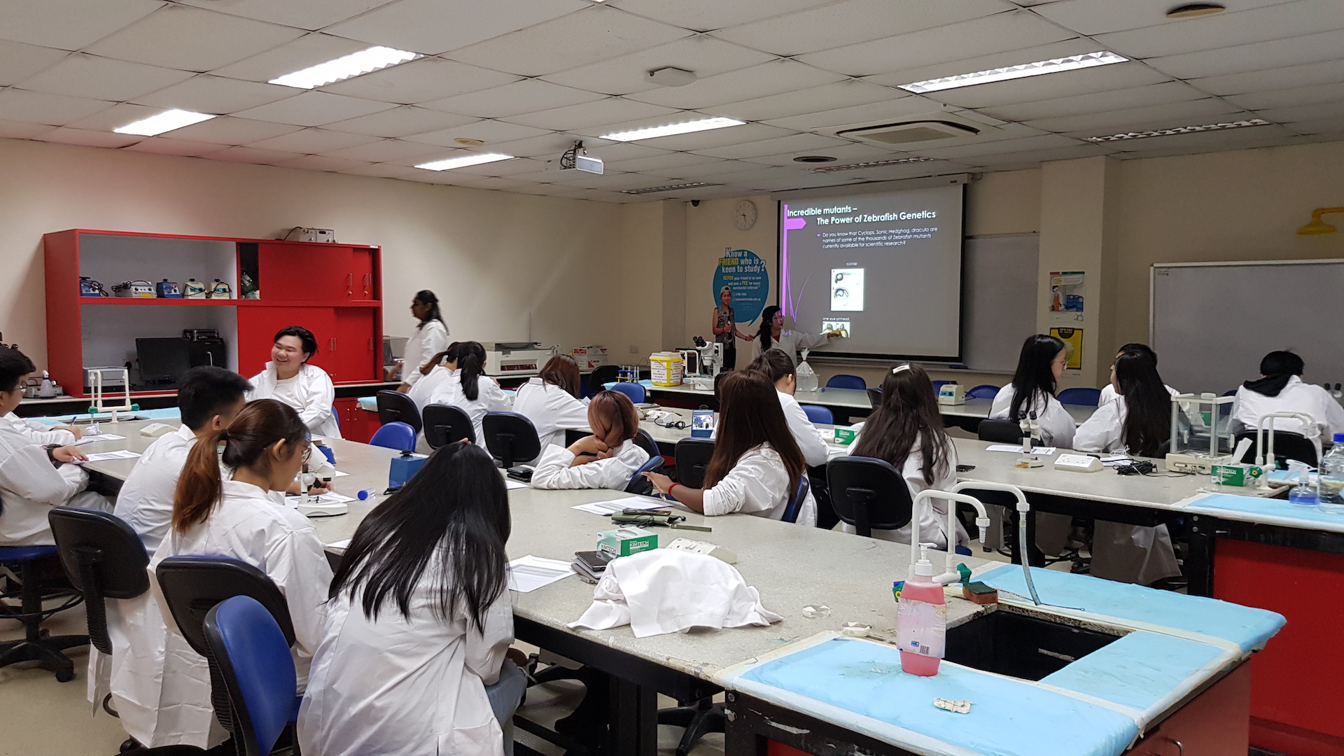 MDIS college students in the science lab.