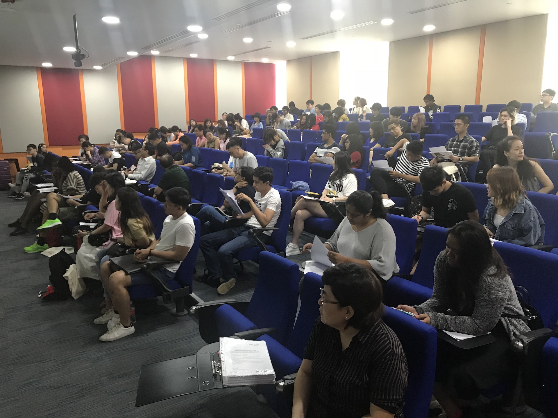MDIS college students taking down notes at a workshop.