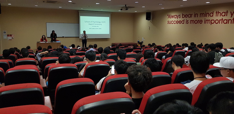 A speaker presenting at the School of Psychology award ceremony.