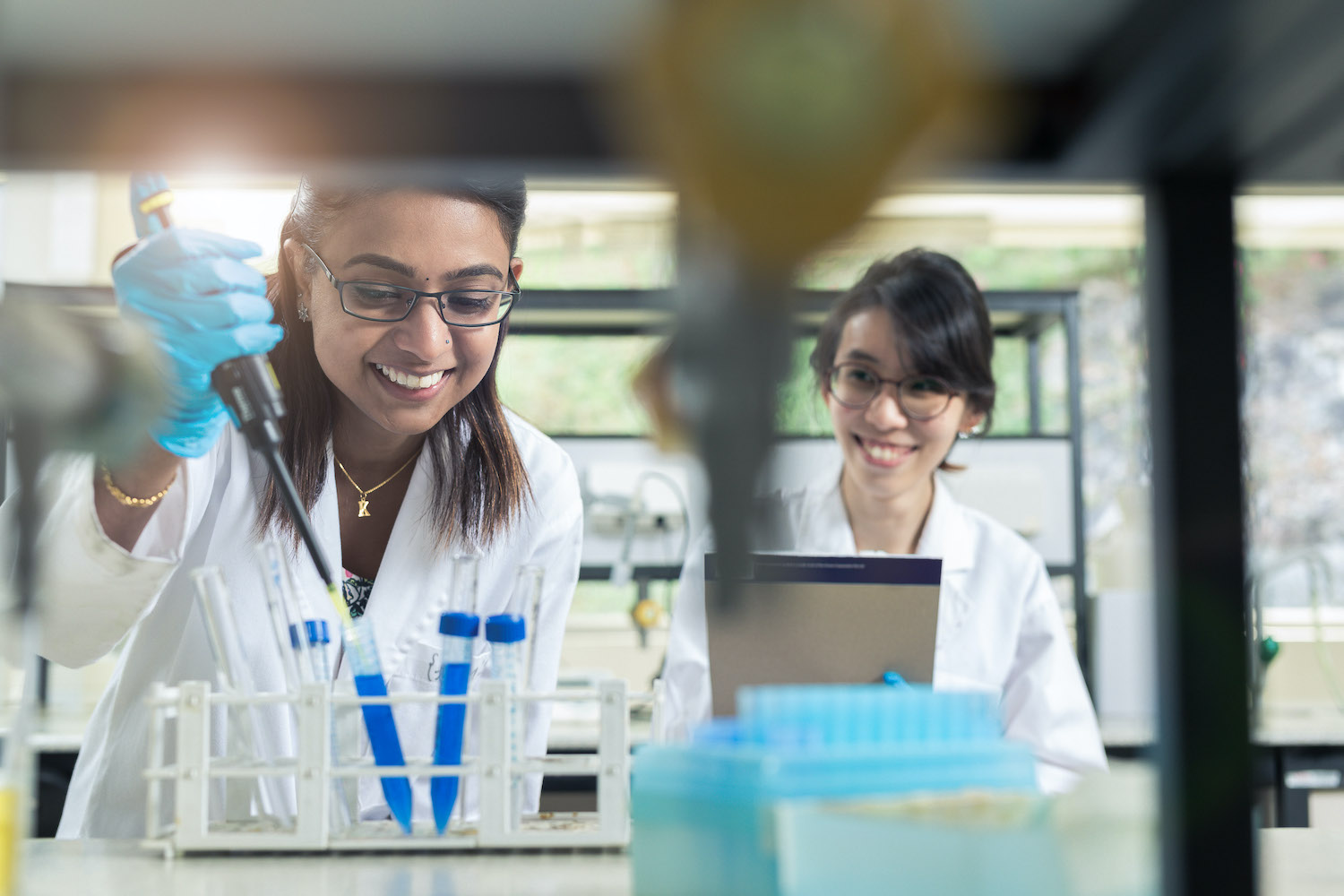 Two MDIS students in the science lab doing experiments.