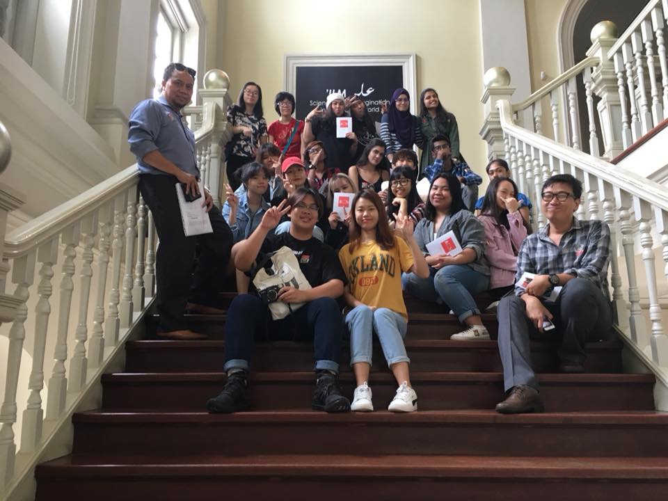 MDIS students posing for a picture in a museum during a school trip.