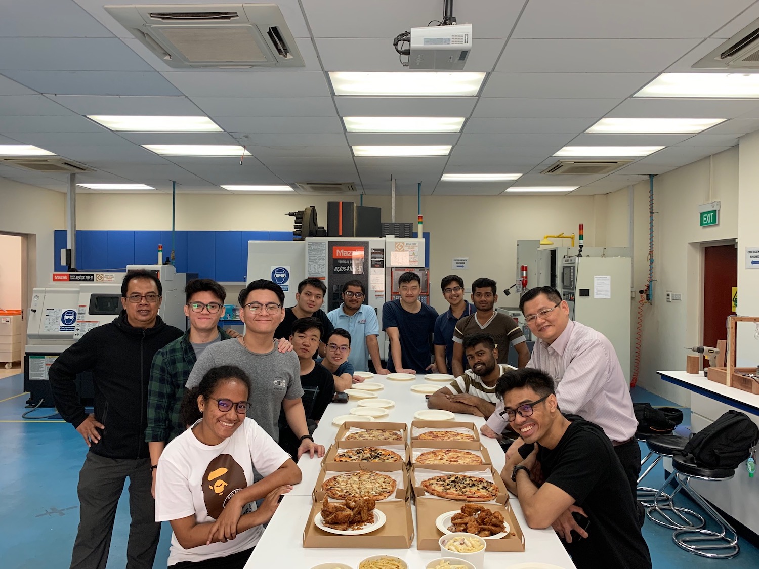 MDIS students having pizza at the engineering lab.