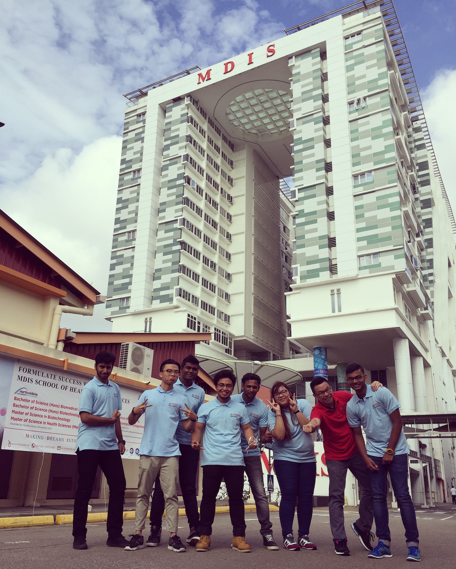 MDIS College students pose for a picture in front of the MDIS student hostel.