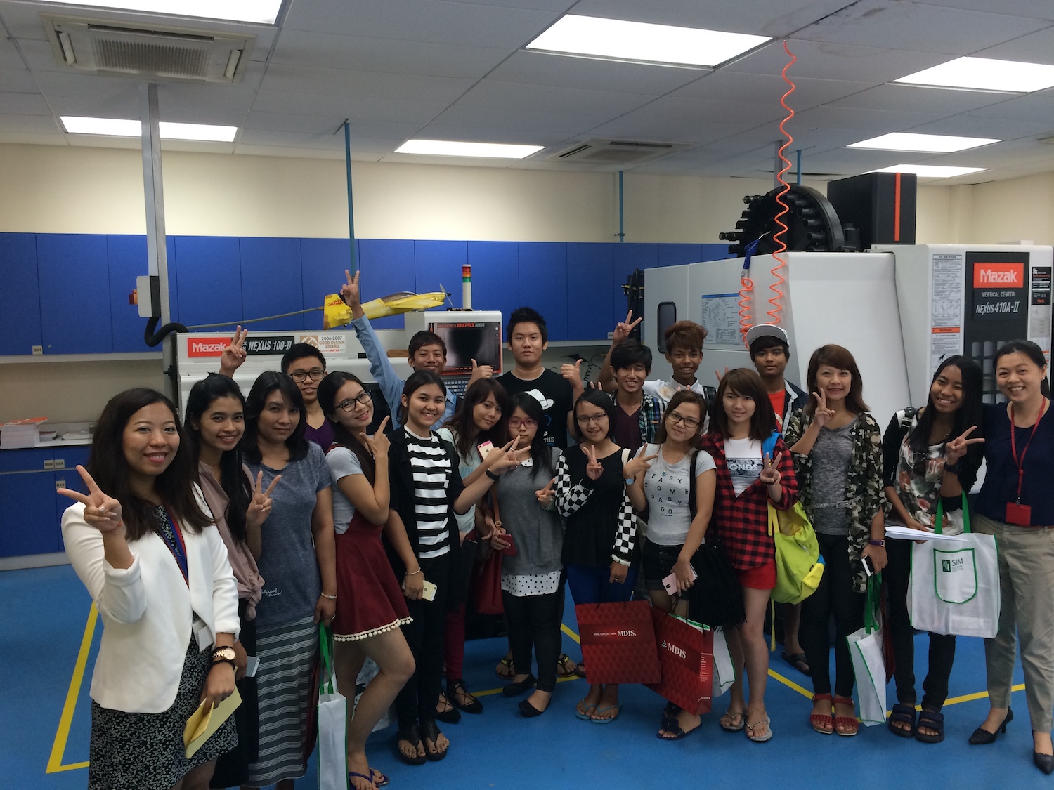 MDIS students posing for a picture in the engineering lab.