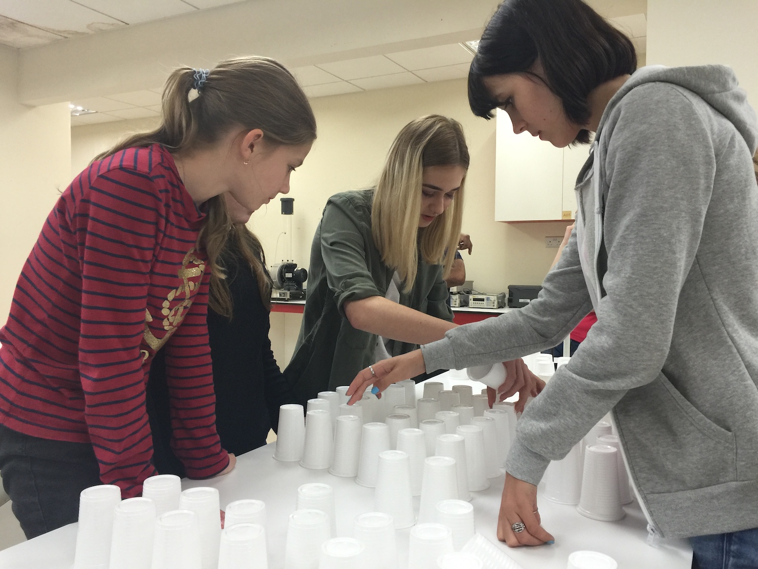 A group of girls arranging cups.