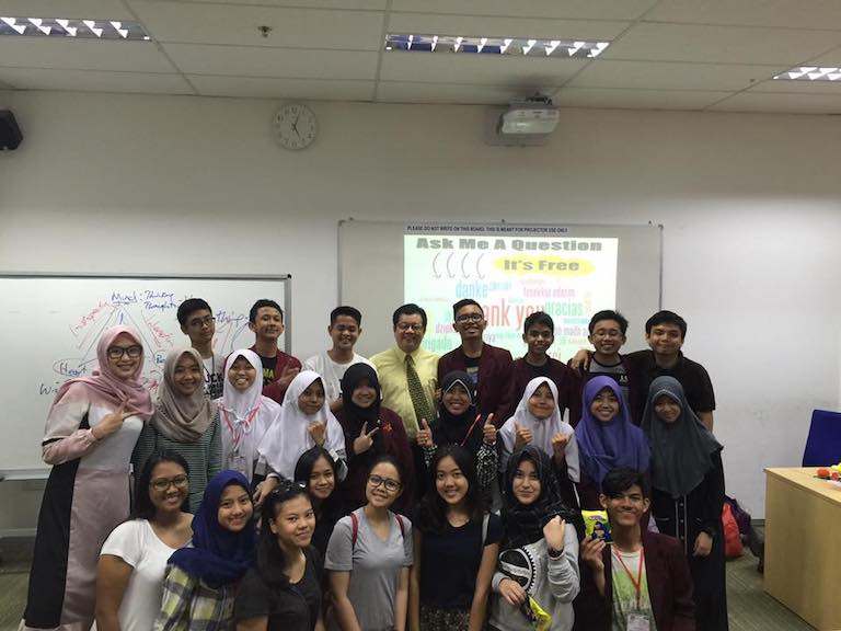 Foreign students posing for a picture in a classroom at MDIS.