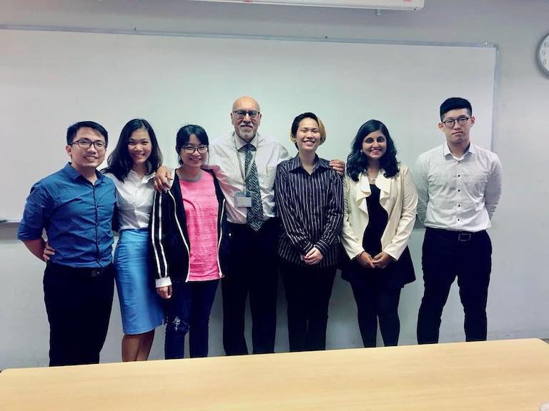 MDIS School of Psychology students posing for a picture with their lecturer.