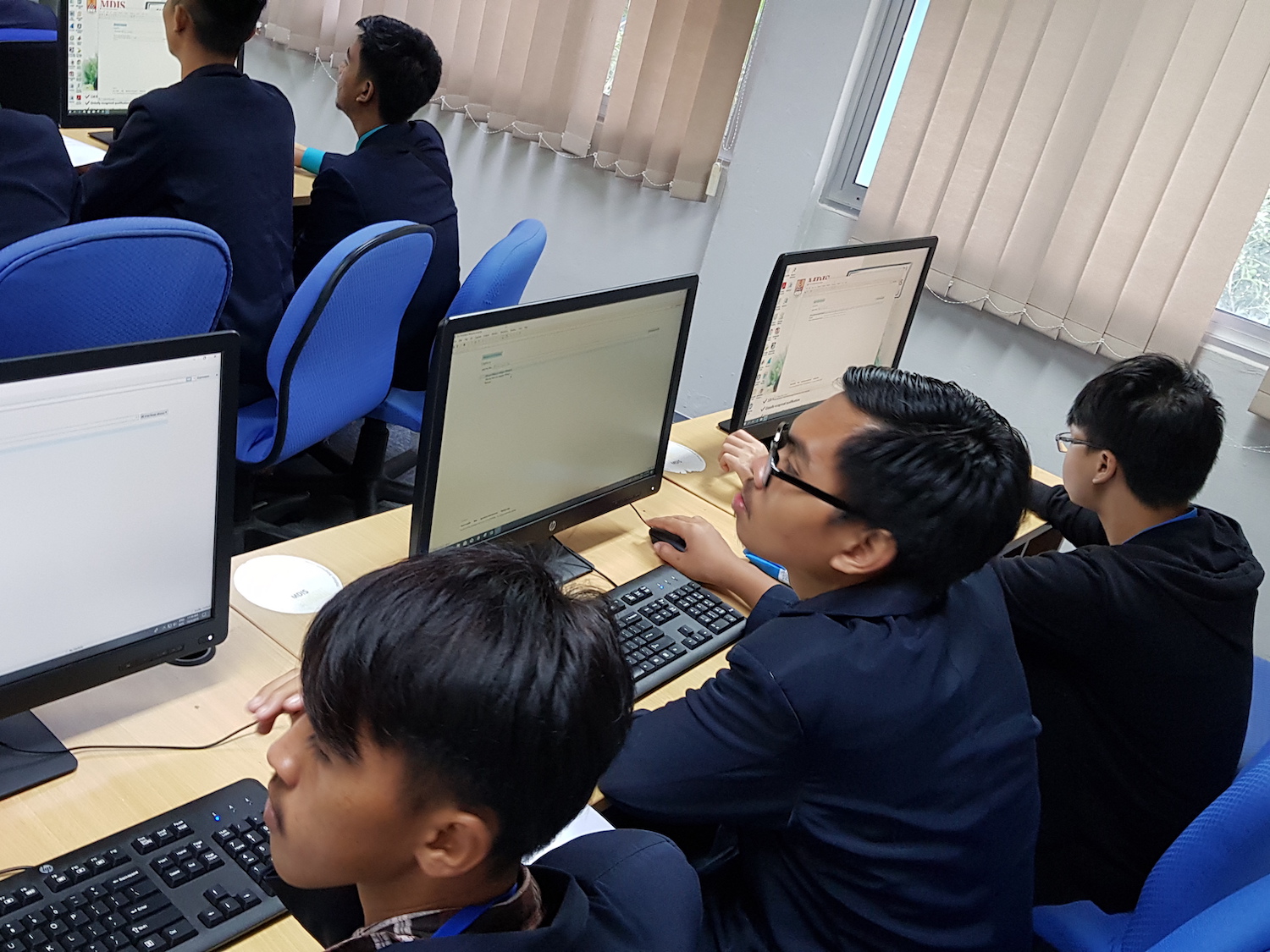 Foreign students listening to an MDIS lecturer speak.