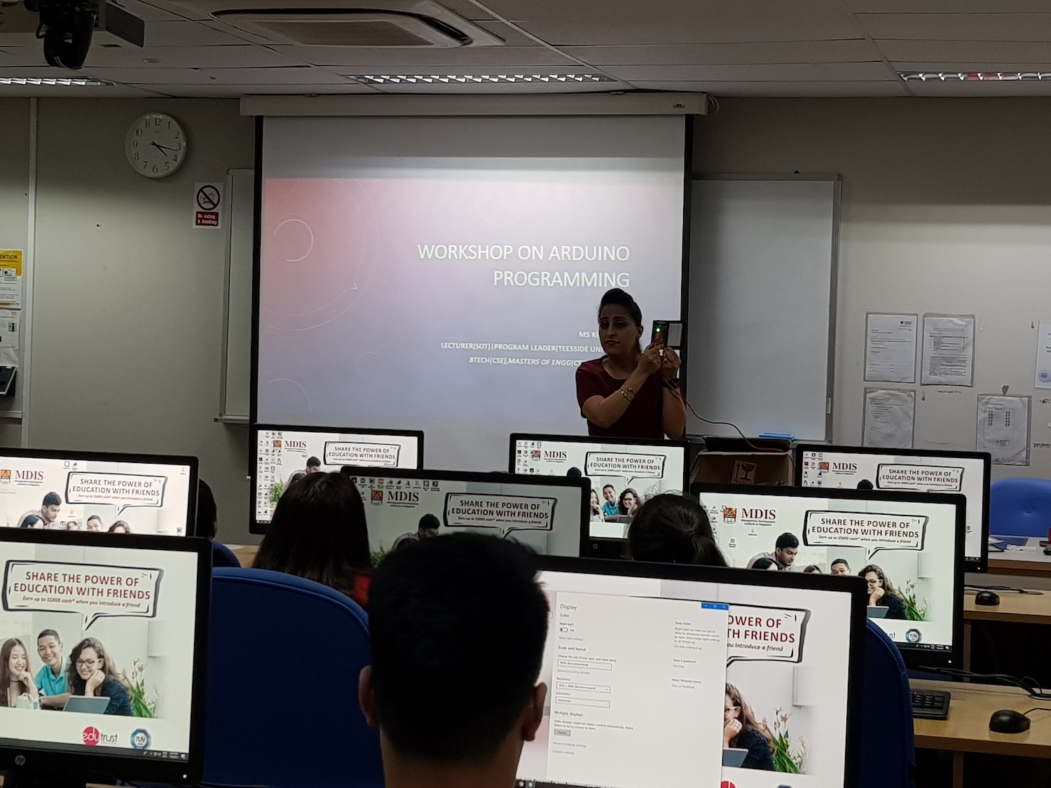 MDIS lecturer shows technical demonstration at a programming workshop.