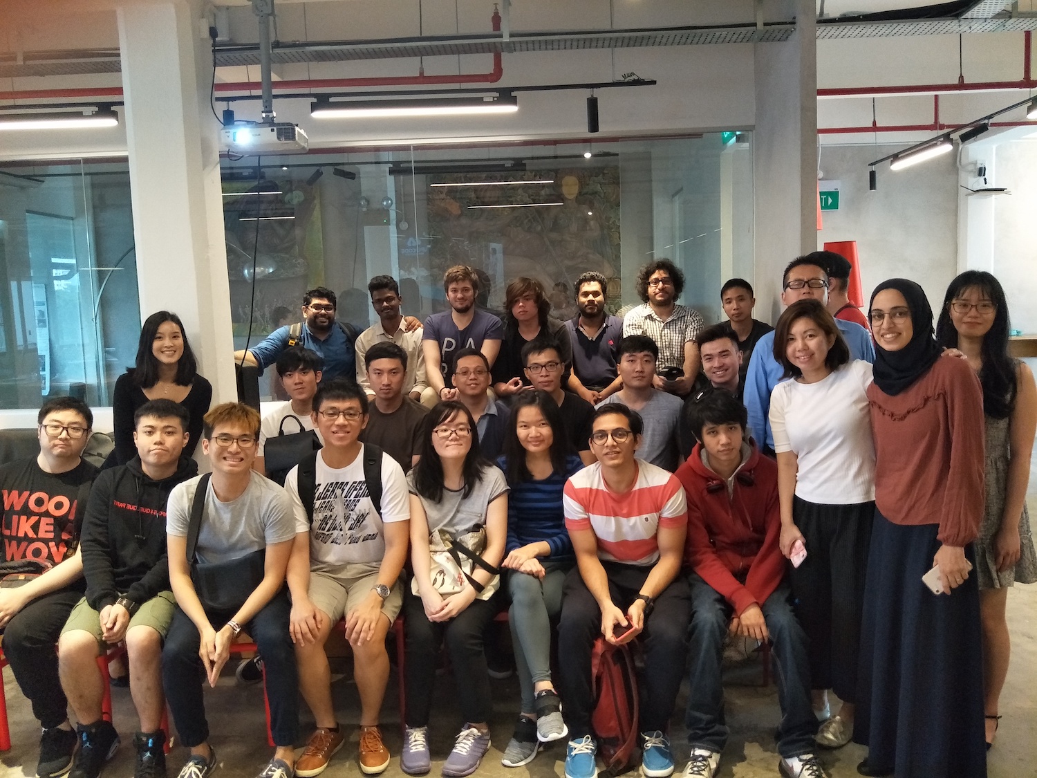 Students posing for a picture during an office tour.