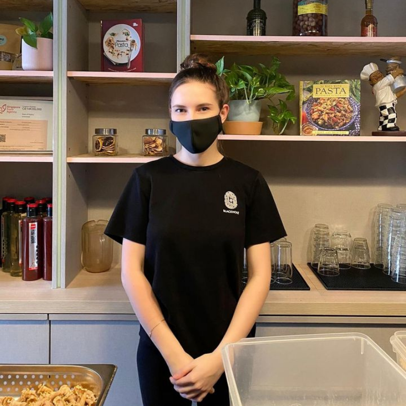 MDIS student poses for a picture during internship at a cafe.