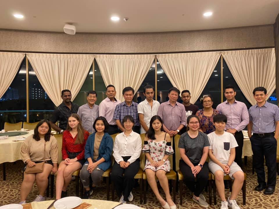 MDIS students posing for a picture in a ballroom.