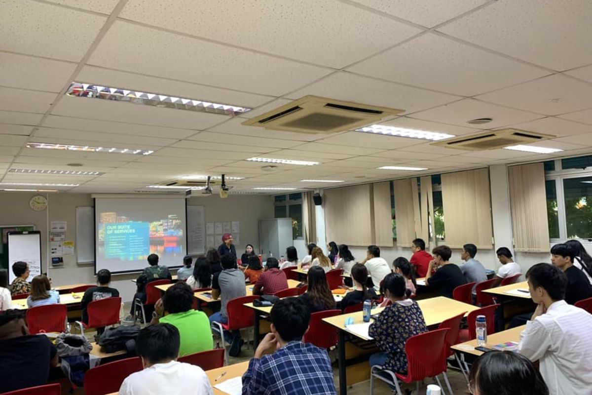 MDIS lecturer speaking to students in a classroom.